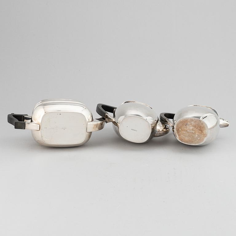 A silver teapot, coffee pot and a hot water pot, including Atkins Brothers, Sheffield 1944.