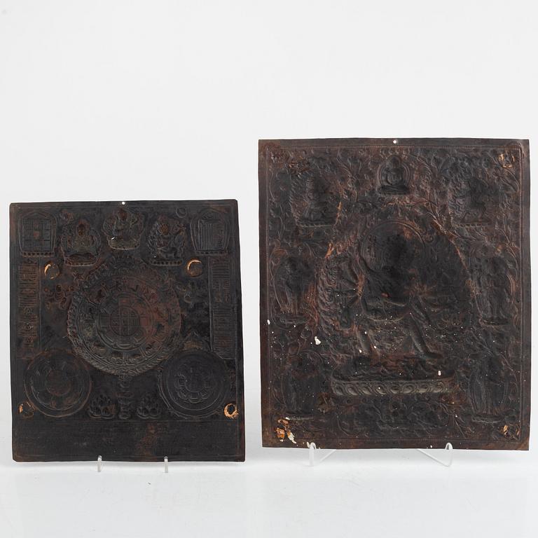 Two Tibetan copper reliefs, 20th century.