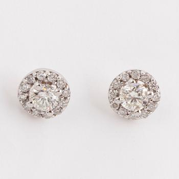 A pair of brilliant-cut diamond earrings.