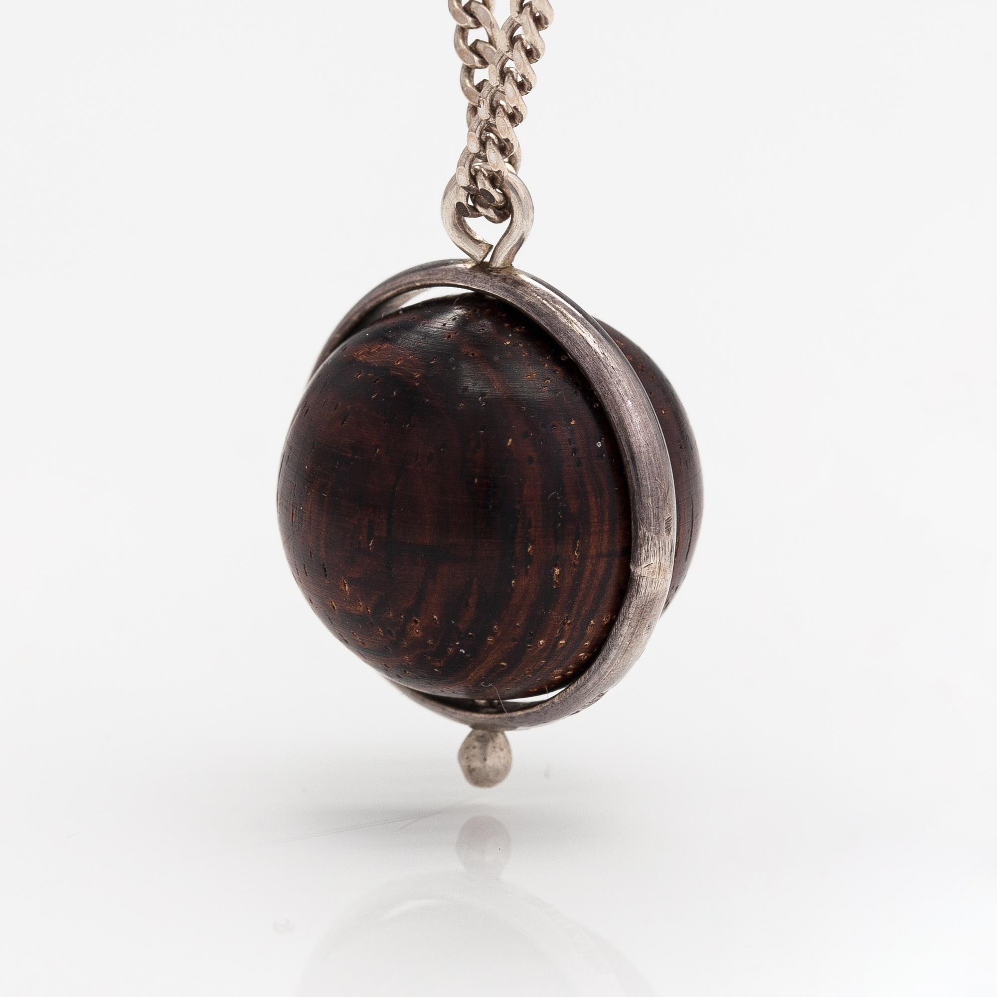 Kaija Aarikka, A necklace, a paid of earrings and a brooch made of silver and wood. Finland.