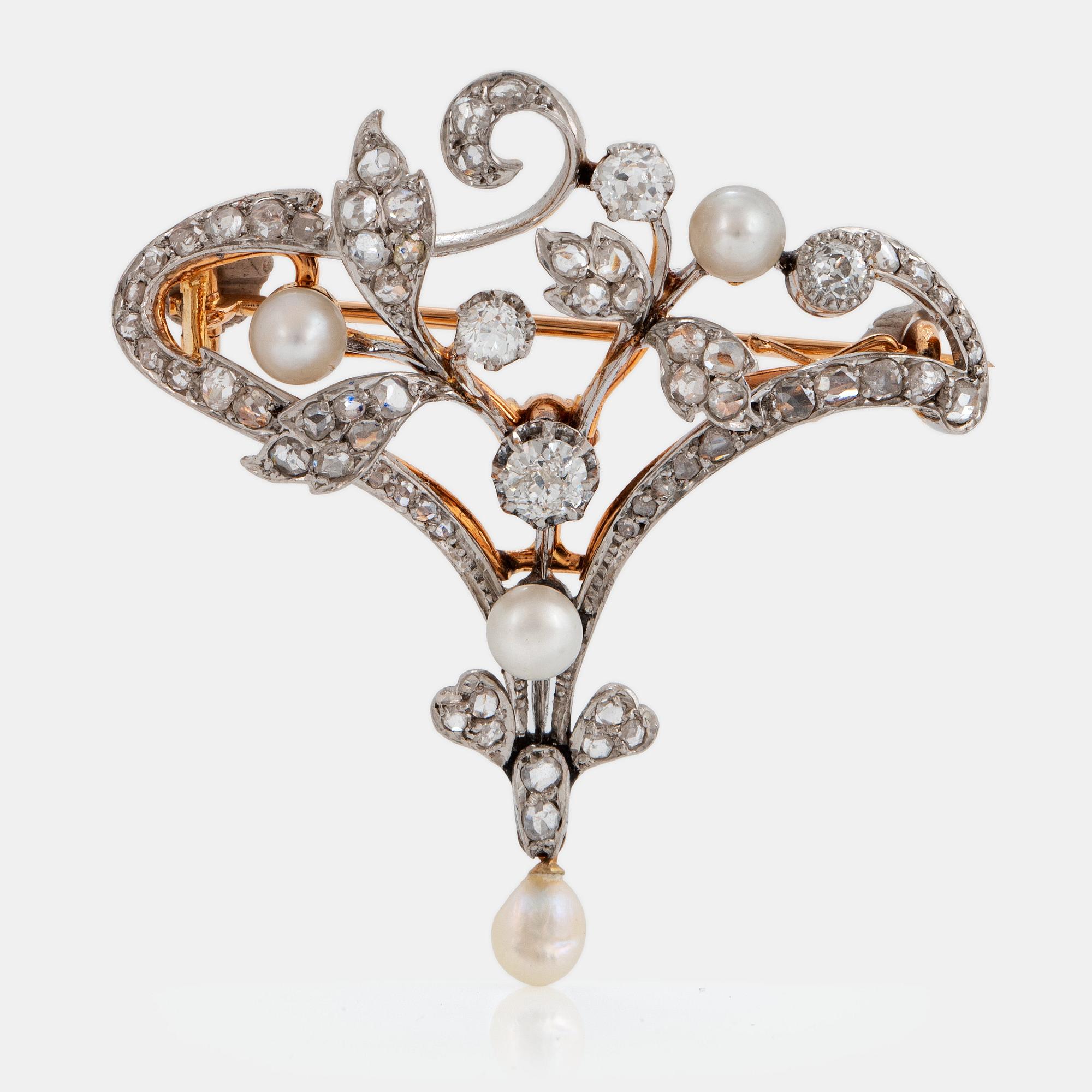 An 18K gold and platinum brooch set with old- and rose-cut diamonds.