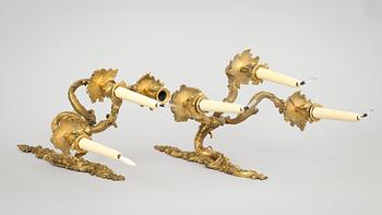 A pair of Louis XV-style 19th century three-light wall-lights.