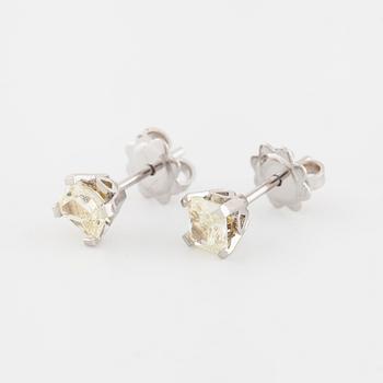A pair of radiant cut diamond earrings.