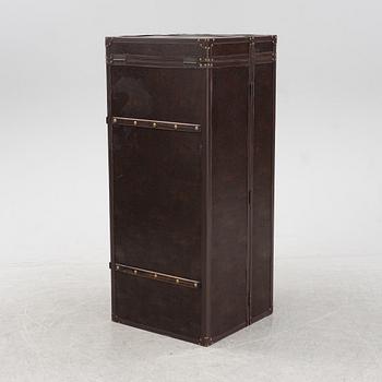 A leather suitcase-shaped bar cabinet.