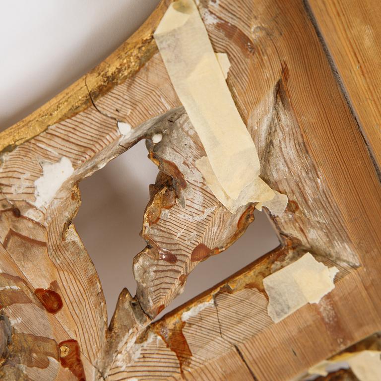 A gustavian giltwood and parcel-gilt mirror by Johan Åkerblad (master 1758-1799).