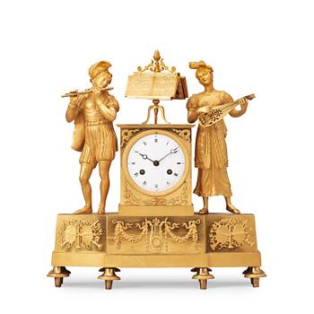 1490. A French "Style troubadour" 19th century gilt bronze mantel clock.