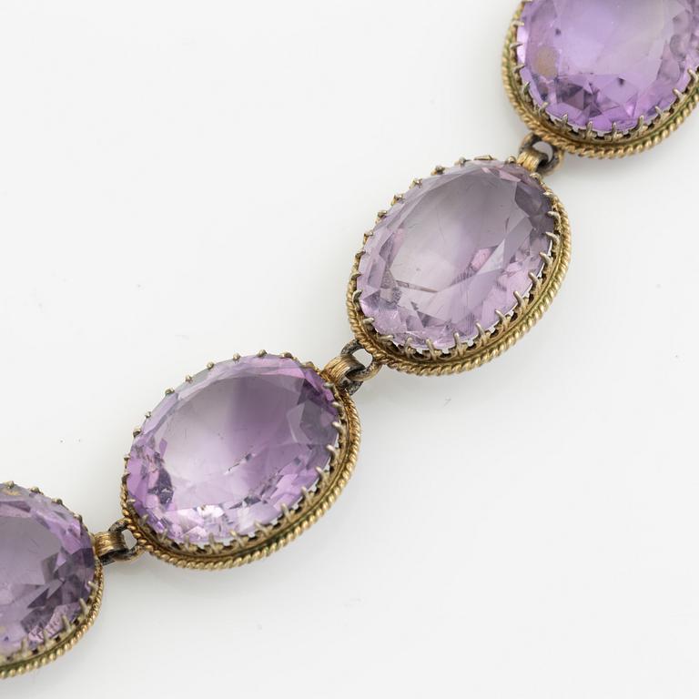 Garniture, necklace and bracelet silver with amethysts, brooch gold-coloured metal with purple paste stones,