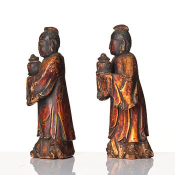 A pair of wooden gilt lacqer figures of officials carrying vases, 17/18th century.