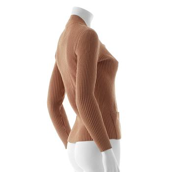 CÉLINE, a beige cardigan.