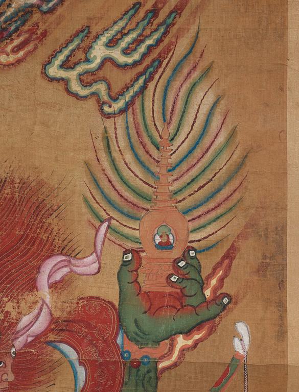 A Tibetan Thangka colour and ink on cloth laid on paper, 19th Century.