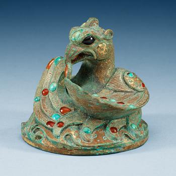 1830. A gilt phoenix shaped bronze weight with inlay of stones.