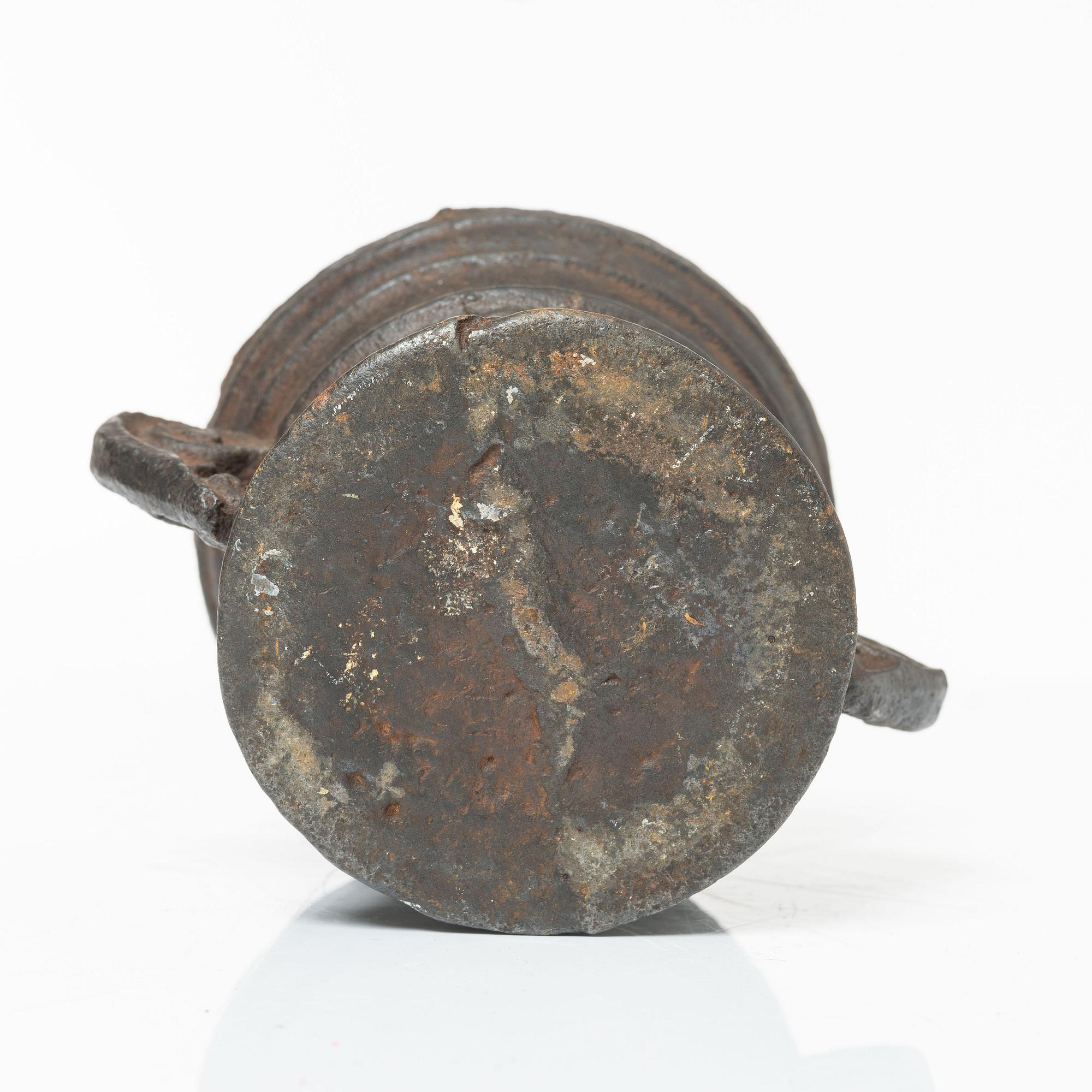 A cast-iron mortar and pestle of renaissance-type, 17th century.