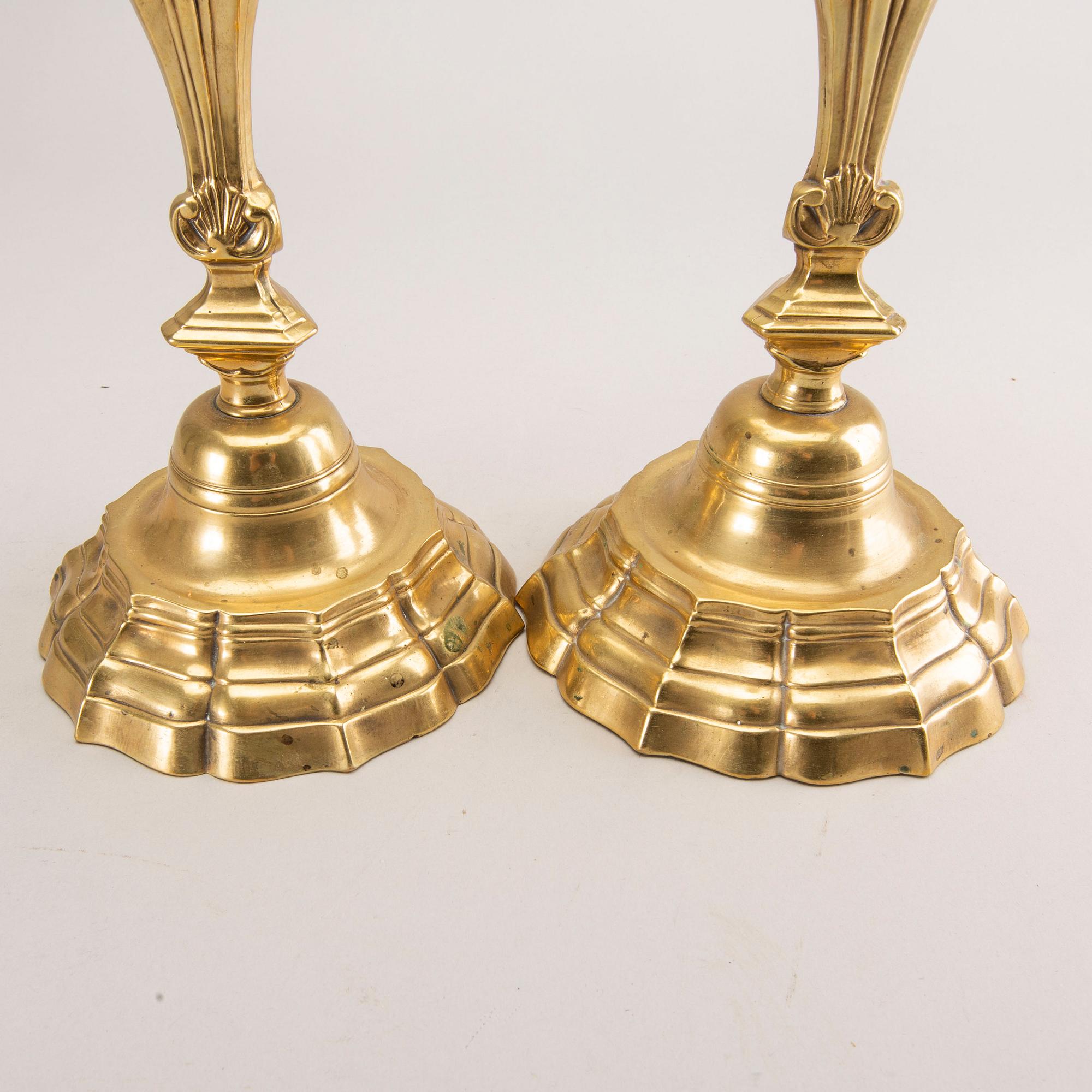 A pair of rococo brass candlesticks, possibly France.