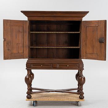 A stained pine Baroque cabinet, on a later stand. From around the year 1700.