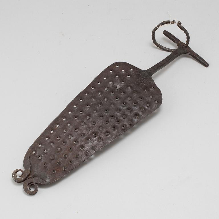 A 18th century iron kitchen tool.