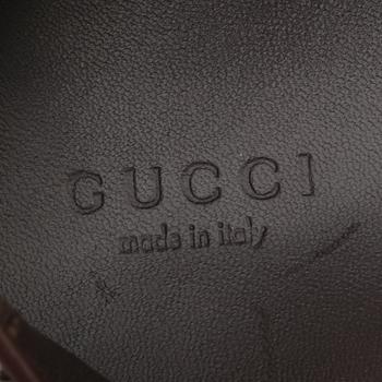GUCCI, a pair of leopard patterned loafers.