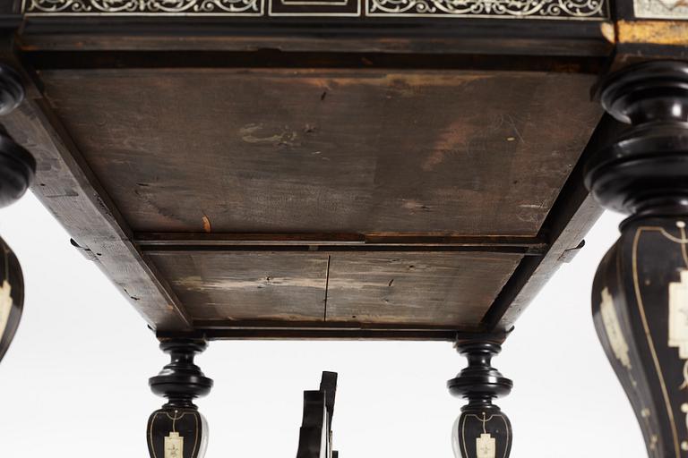 A Renaissance-style ebony, ebonized and ivory-inlaid library table, late 19th century, presumably Germany.