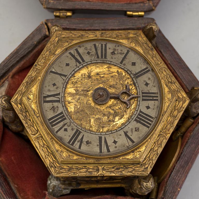 A gilded brass baroque travel clock from around 1700, with original case.