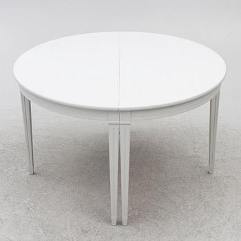 A pair of crescent shaped tables, 20th century.