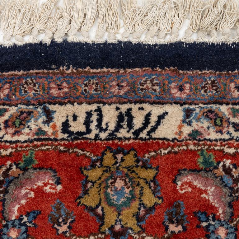 A Mashad carpet, signed, c. 289 x 198 cm.