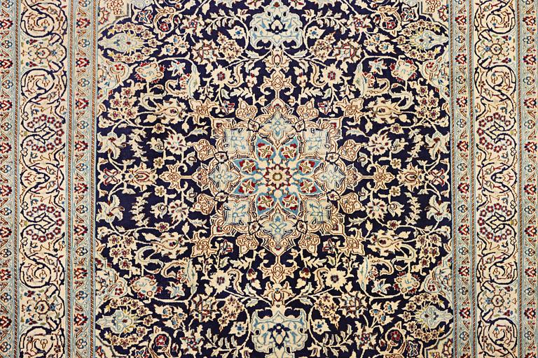 A Nain carpet, part silk, c. 338 x 244 cm.