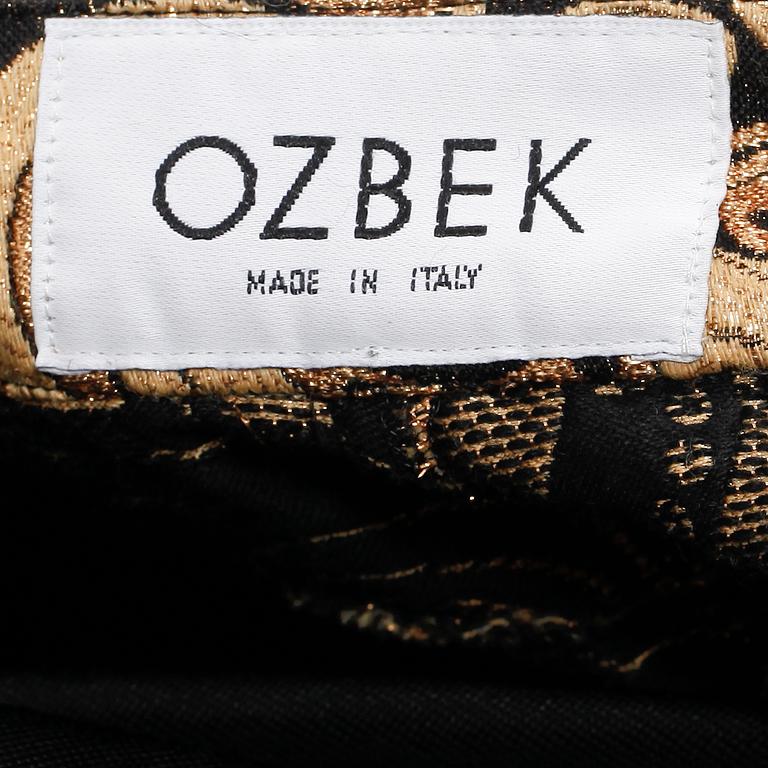 OZBEK, a polo-neck sweater and trousers.