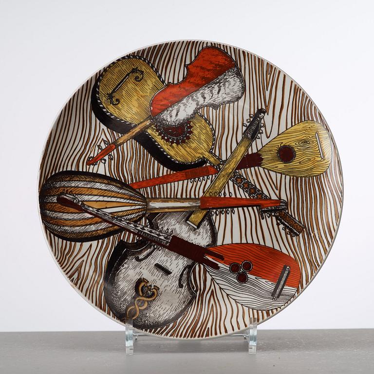 A set of six Piero Fornasetti 'Strumenti Musicali' porcelain plates, Milano, Italy.