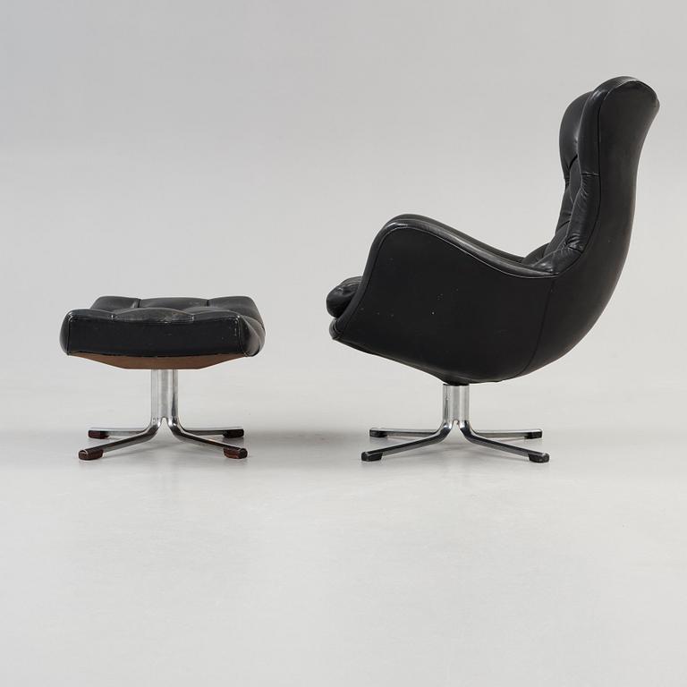 A Gustav Axel Berg 'Status' black leather easy chair with ottoman, Bröderna Andersson 1960's-70's.