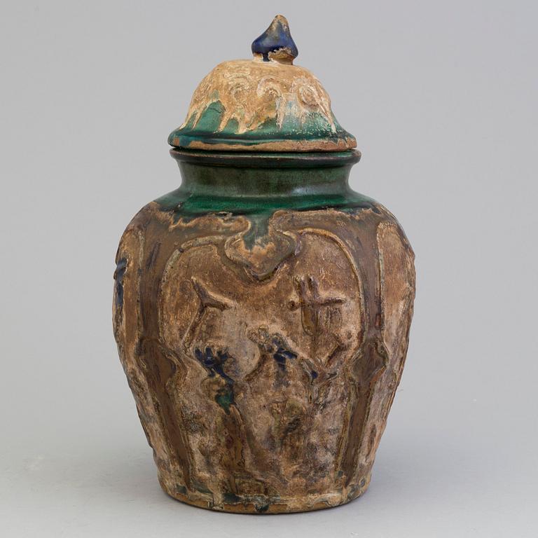 A Chinese 'Shiwan' ware pottery jar with cover, Qing dynasty, 19th century.