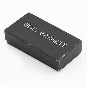 Earrings, possibly Slim Barrett.