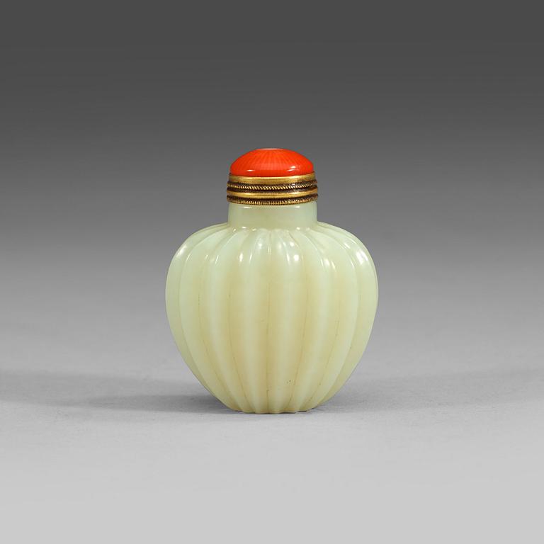 A finely carved nephrite snuff bottle with stopper, China.