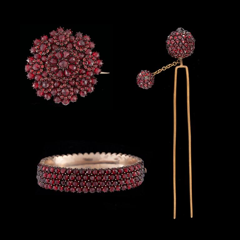 A granet bracelet, hair-pin and brooch set in yellow metal.