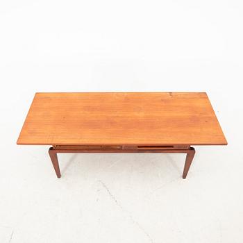 A teak coffee table from the middle of the 20th century.