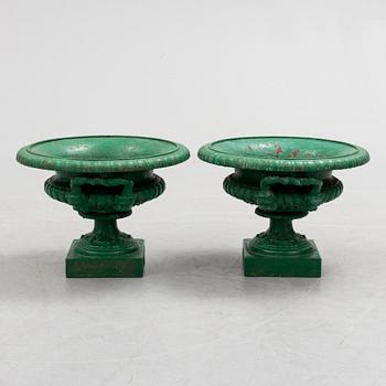 A pair of cast iron garden urns by Husqvarna, circa 1900.