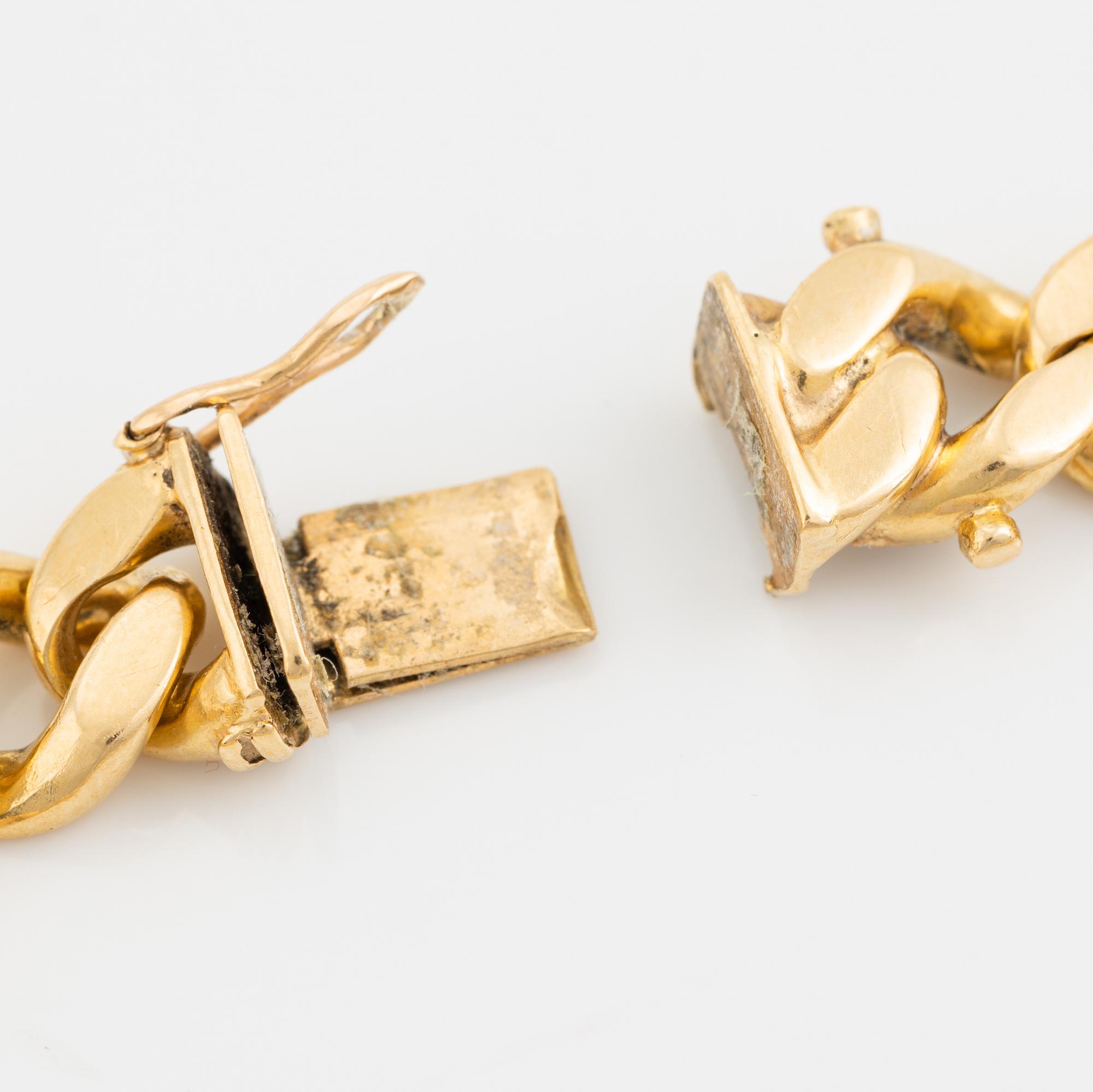 18K gold curb link bracelet.