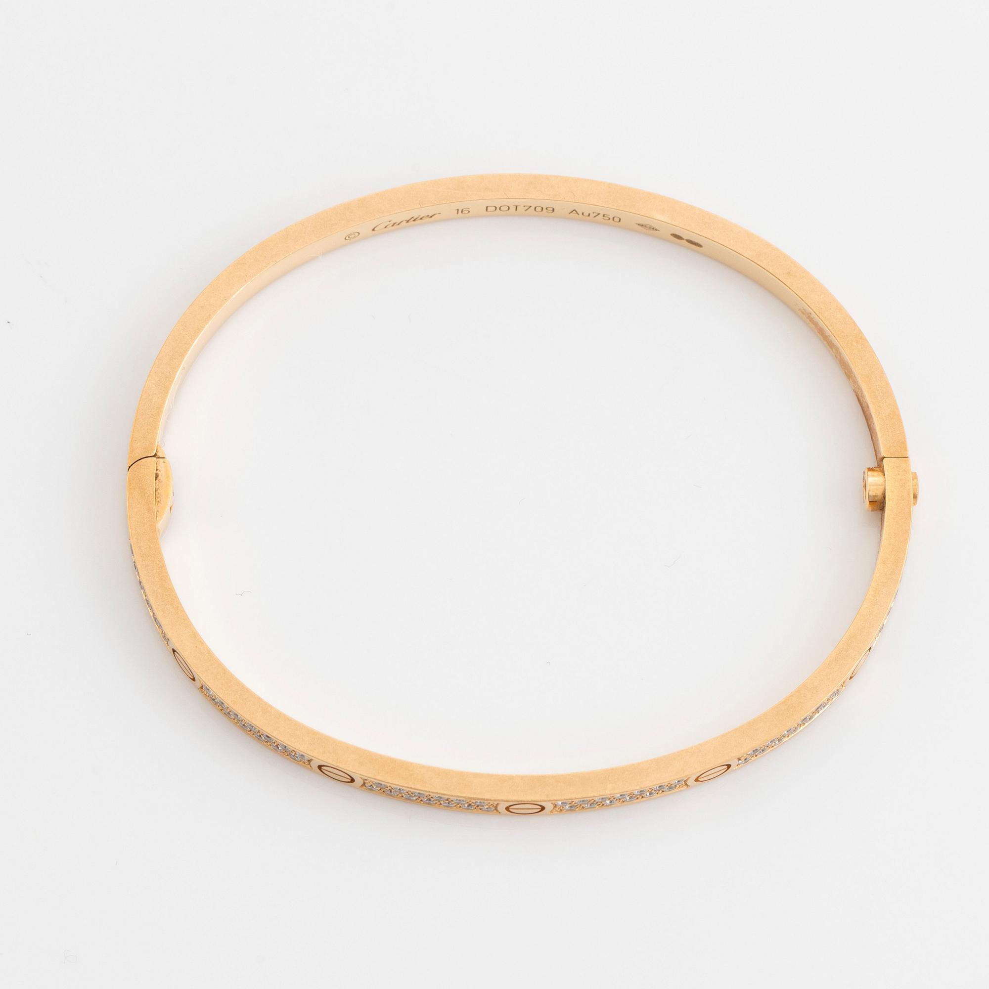 A Cartier Love bracelet small model in 18K gold set with round brilliant cut diamonds. size 16 total weight 17 g. Signed Cartier numbered DOT70. Bukowskis