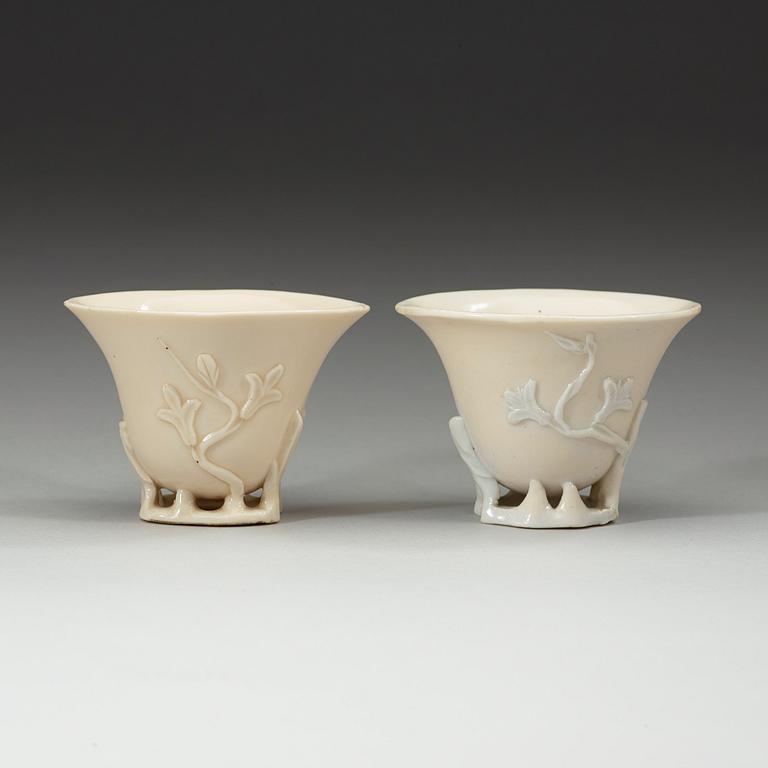 A pair of blanc de chine libation cups, Qing dynasty 18th century.