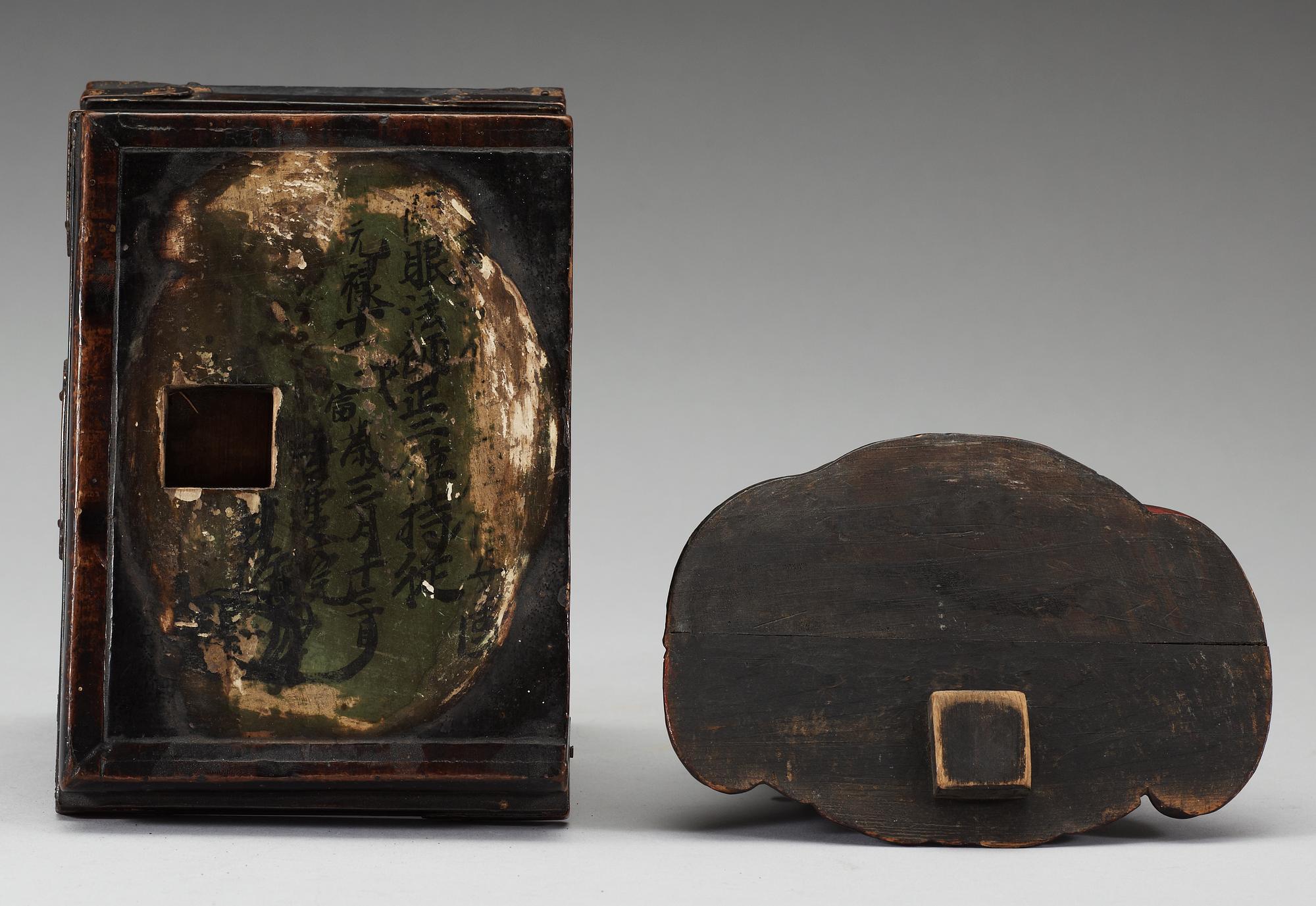 A lacquered wooden Japanese deity on a stand, 19th Century.