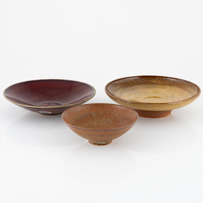 A group of three bowls, including Henning Nilsson, Höganäs.