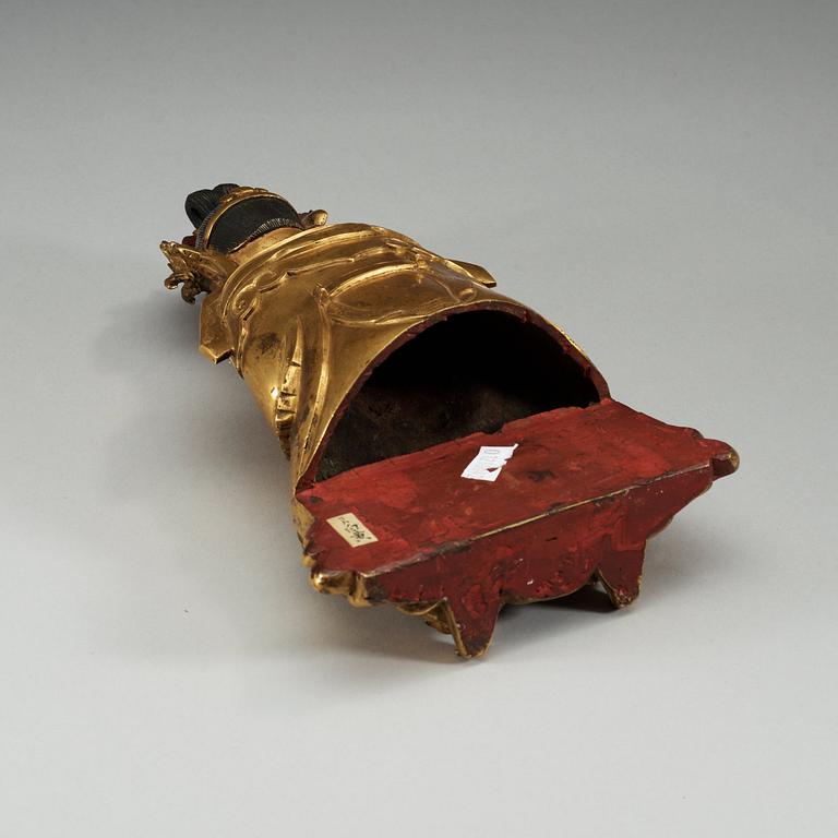 A gilt bronze figure of a sitting female deity, Qing dynasty, 18th Century.