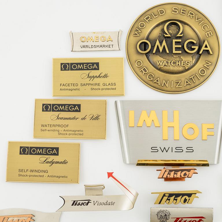 A collection of shop signs and agent plaques from Swiss watchmakers.