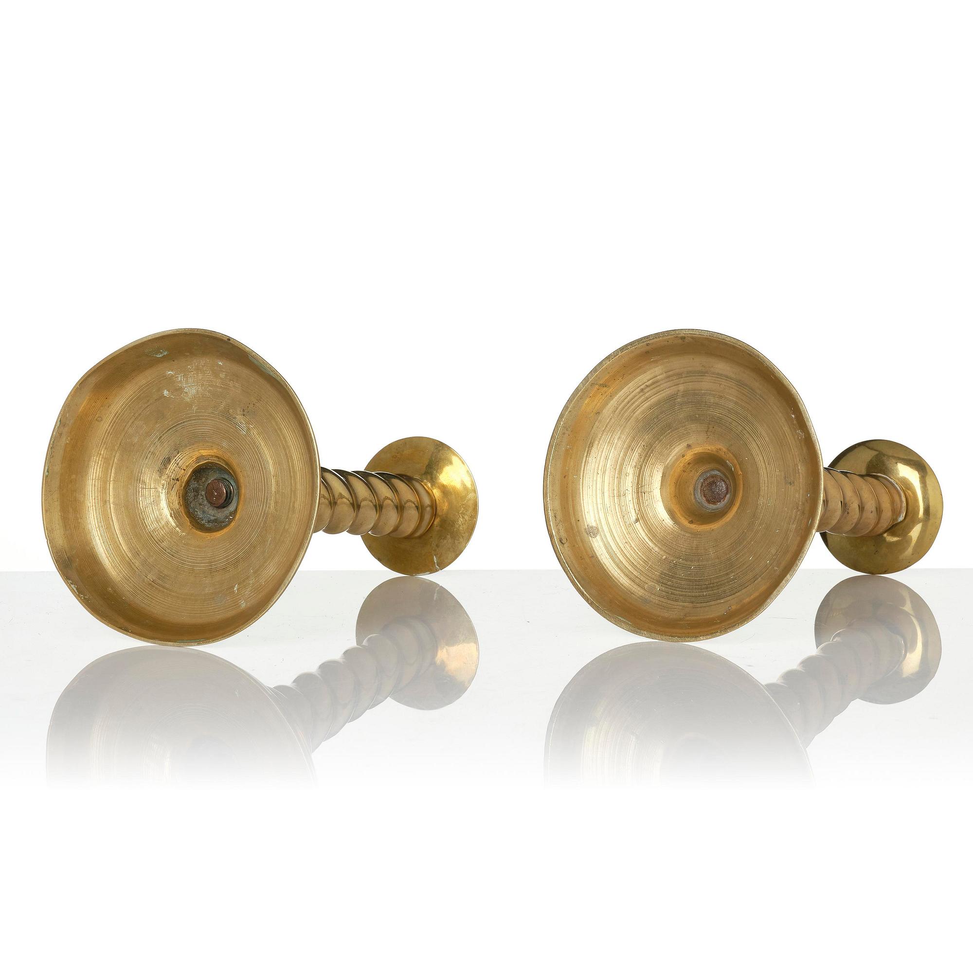 A pair of Northern European cast brass baroque candlesticks, circa 1700.