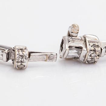 An 18K white gold bracelet set with baguette and brilliant-cut diamonds.