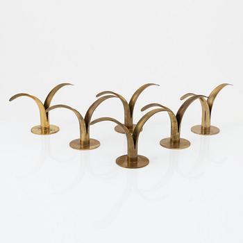 Ivar Ålenius-Björk, a set of eight brass candleholders, including 'Liljan', from Ystad Metall, mid 20th Century.