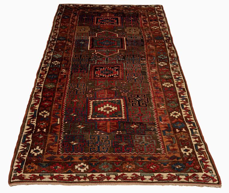 An antique Kurdish / Turkish carpet by the Herki Tribe, ca 276 x 116 cm.