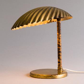 PAAVO TYNELL, A DESK LAMP. A shell.  Manufactured by Taito Oy. Designed in 1938/39.