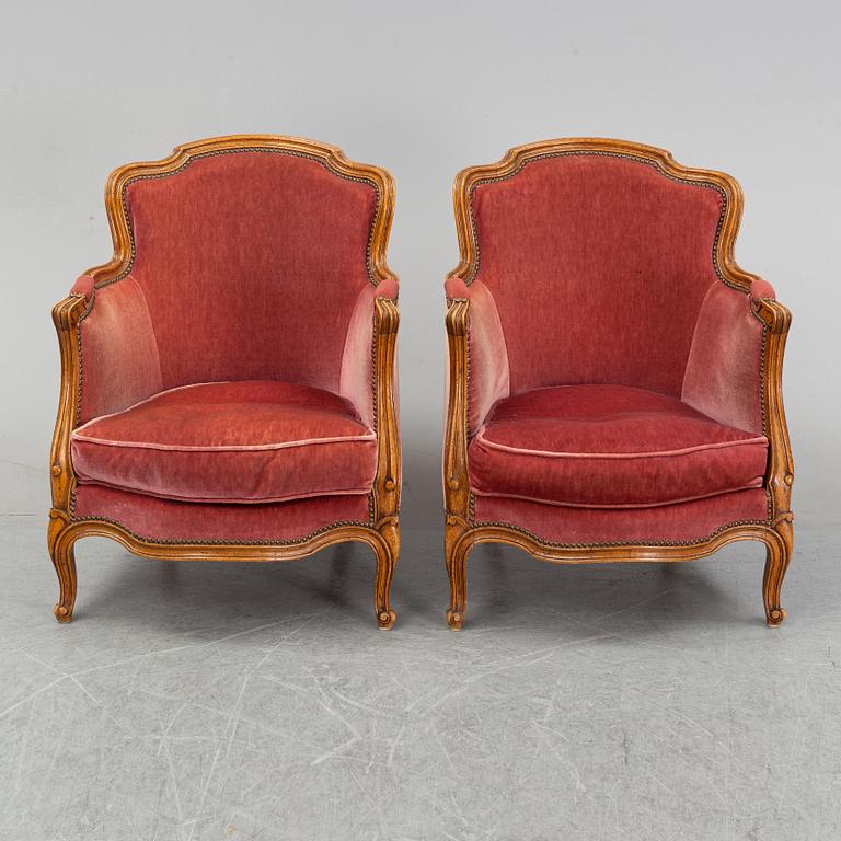 A pair of rococo style easy chairs from around the year 1900.