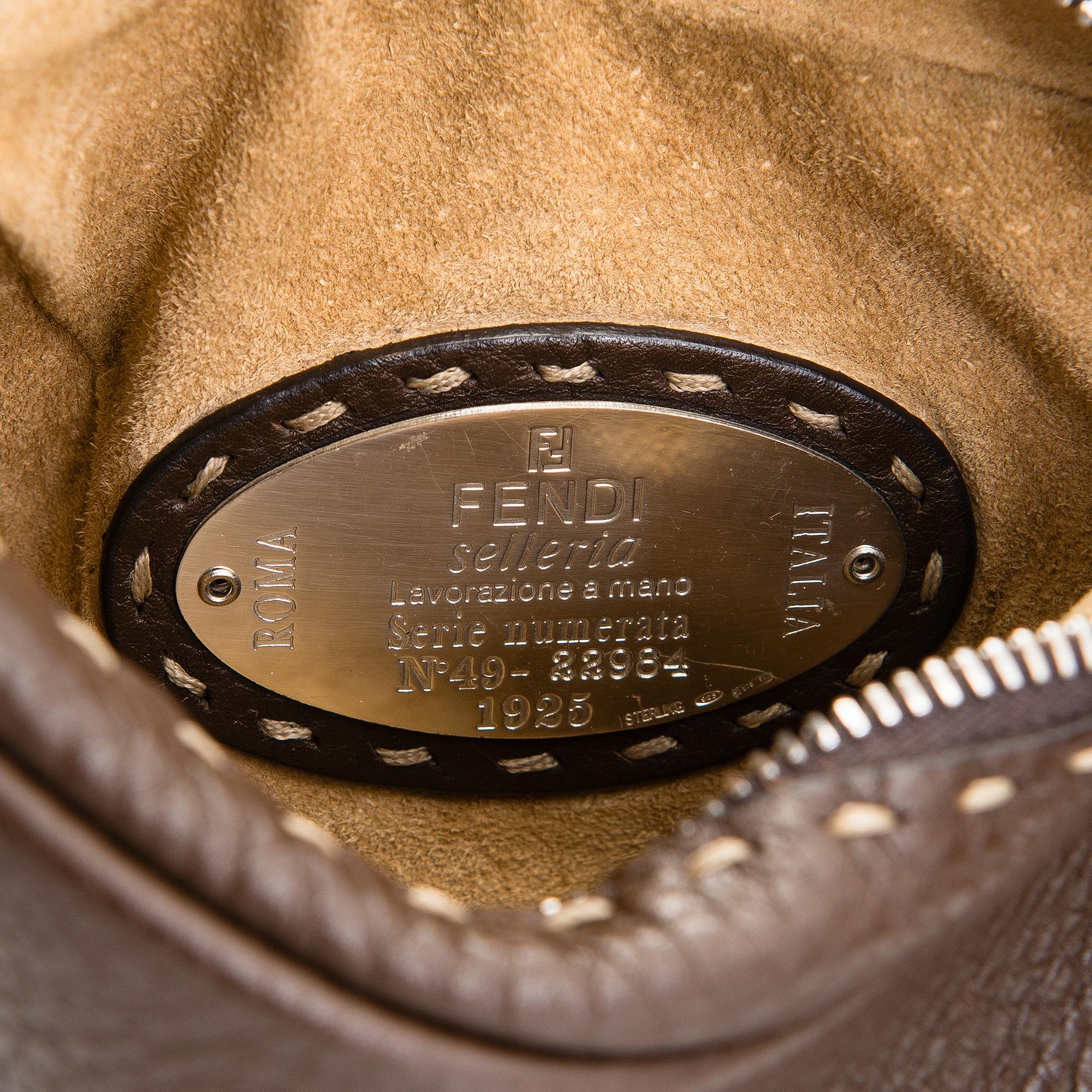 Fendi, a brown leather bag.