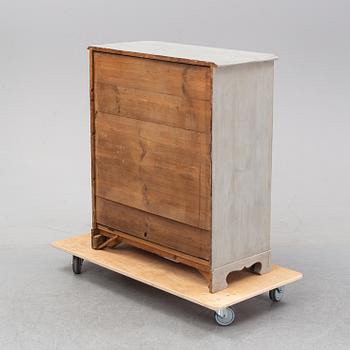 A painted chest of drawers from around the year 1900.