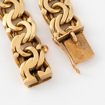 An 18K gold bracelet.